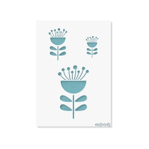 May include: A white rectangular stencil featuring three cut-out flower designs in varying sizes. Each flower has a semi-circular base, a vertical stem, two pairs of oval leaves, and a top section with radiating lines ending in small circles. The text mostencils is printed in the bottom right corner.