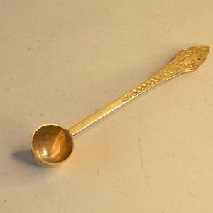Old brass spoon for the coffee can, motif water carrier