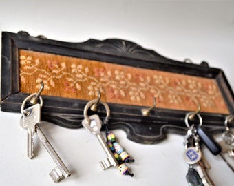 very old keyboard with hand-embroidered flowers