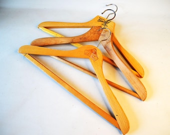 3 sturdy vintage clothes hangers with advertising. K