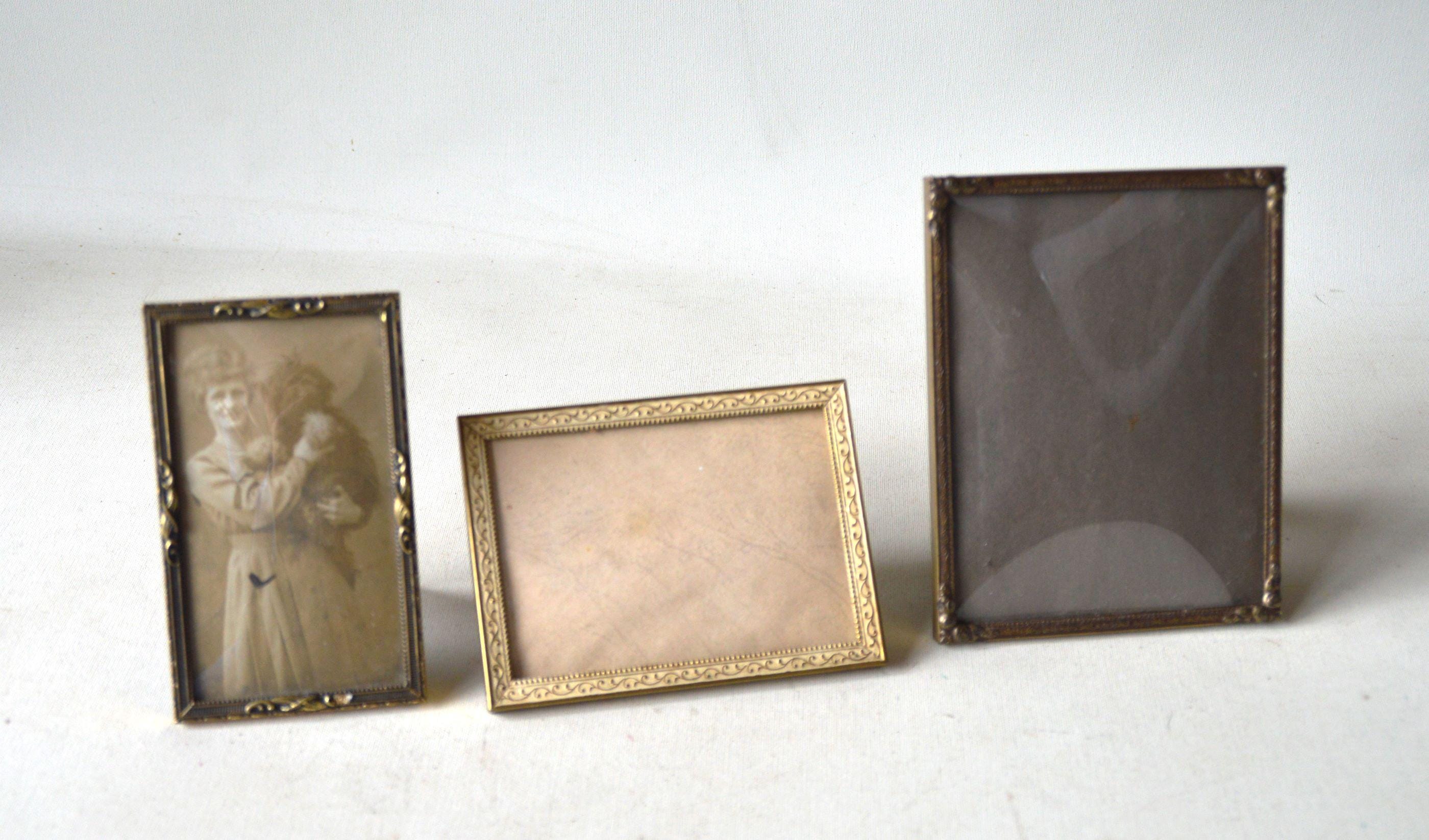 Small vintage brass photo frames with domed glass. E