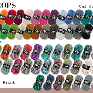 以下が含まれることがあります： さまざまな色と模様の糸玉。糸は「Fabel」とラベル付けされており、「Uni Color」、「Print」、「Long Print」の3つの列に並んでいます。