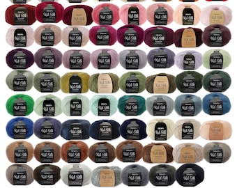 May include: A collection of sixty-four balls of Drops Kid Silk yarn arranged in a grid, each featuring a paper label with the text Drops Kid Silk. The yarn balls display a wide variety of solid colors, including shades of white, red, blue, green, brown, and gray.