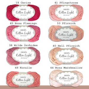 May include: Eight skeins of DROPS Cotton Light yarn in various shades of pink, from a deep red to a light peach. Each skein has a white label with the brand name and yarn type.