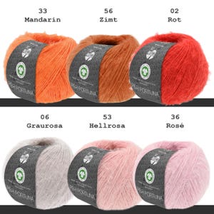 May include: Six balls of Per Fortuna yarn arranged in two rows. Top row: Mandarin orange, Zimt brown, and Rot red. Bottom row: Graurosa grey, Hellrosa light pink, and Ros&eacute; pink. Each ball features a dark grey label with white text and a green logo.