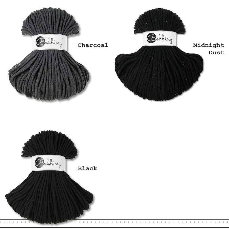 May include: Three skeins of Bobbiny cord in charcoal, midnight dust, and black. Each skein is secured with a white paper band featuring the Bobbiny logo. The charcoal cord is dark gray, while the midnight dust and black cords are solid black.