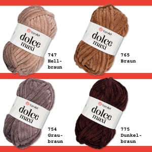 May include: Four balls of yarn in different shades of brown. The yarn is labeled "dolce maxi" and is from the brand "YarnArt". The yarn is labeled with numbers 747, 754, 765, and 775. The colors are light brown, gray-brown, brown, and dark brown.