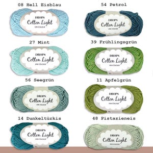 May include: A collection of eight skeins of DROPS Cotton Light yarn in various colors, including light blue, teal, mint green, apple green, seafoam green, dark turquoise, and pistachio. Each skein has a label with the DROPS logo and the yarn name.