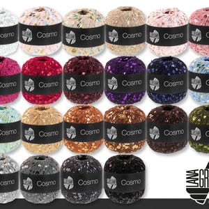 May include: A collection of Cosmo yarn balls in various colors, including white, pink, red, purple, blue, green, gold, brown, and black. Each ball is wrapped with a black label that reads "Cosmo". The Lana Grossa logo is in the bottom right corner.