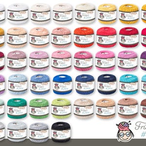 Op de afbeelding: Een verzameling garen in verschillende kleuren, waaronder wit, geel, rood, roze, blauw, groen en bruin. Elk garen heeft een label met de tekst "Frida's #24te" en een cartoonafbeelding. Het garen is netjes gerangschikt en toont een breed scala aan tinten.