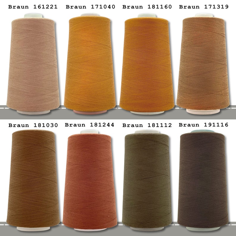 May include: Eight spools of thread in various shades of brown, beige, and orange. The spools are labeled with the brand name "Braun" and a number.