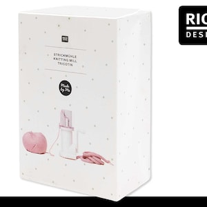 May include: White box with a pink knitting mill, a ball of pink yarn, and a length of pink knitted fabric. The box has a white background with small black dots and the text "STRICKMÜHLE KNITTING MILL TRICOTIN Made by Me" and the Rico Design logo.