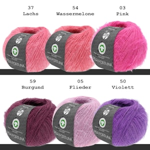 May include: Six balls of Per Fortuna yarn arranged in two rows. Top row: salmon, watermelon, and pink. Bottom row: burgundy, lilac, and violet. Each ball features a dark gray paper band with the text Per Fortuna and a circular green logo.