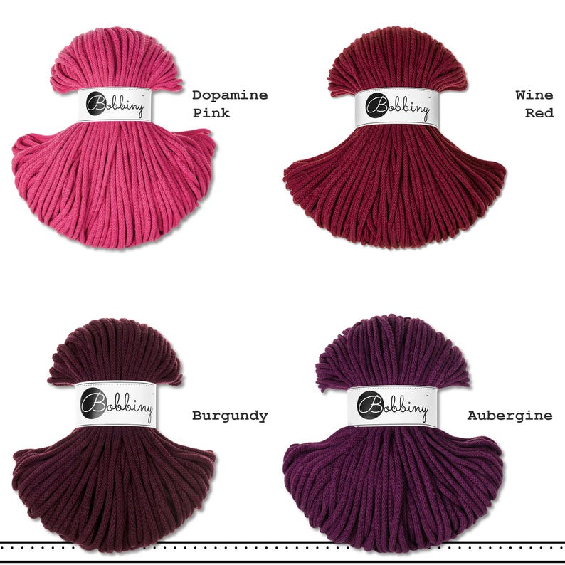 May include: Four skeins of Bobbiny cotton cord arranged in a grid. The colors are labeled as Dopamine Pink, Wine Red, Burgundy, and Aubergine. Each skein is wrapped with a white paper band featuring the Bobbiny logo in black text.