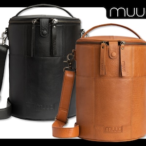 May include: Two leather cylindrical bags with adjustable straps. The bag on the left is black and the bag on the right is brown. Both bags have the word "muud" embossed on the front.