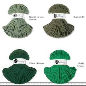 May include: Four bundles of Bobbiny cord in shades of green. Each bundle is secured with a white paper band featuring the Bobbiny logo. The colors are labeled as Eucalyptus Green, Avocado, Pine Green, and Jade Green, arranged in a grid layout.