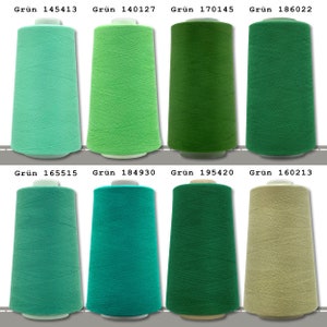 May include: Eight spools of thread in various shades of green, teal, and beige. The spools are labeled with the color "Gr&uuml;n" and a number.