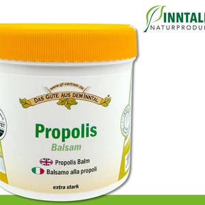 May include: A white jar with a yellow lid labelled "Propolis Balsam" with the text "Das Gute Aus Dem Inntal" and "extra stark". The jar is a natural product from Inntaler Naturprodukte.