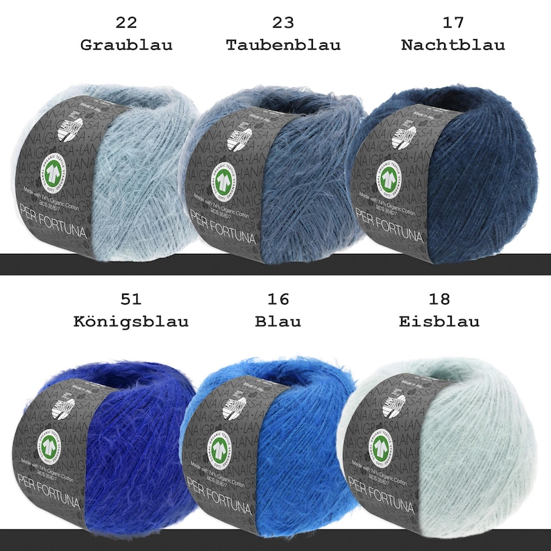 May include: Six balls of fuzzy yarn in various shades of blue, labeled with numbers and names including Graublau, Taubenblau, Nachtblau, K&ouml;nigsblau, Blau, and Eisblau. Each ball features a dark paper band with the text Per Fortuna.