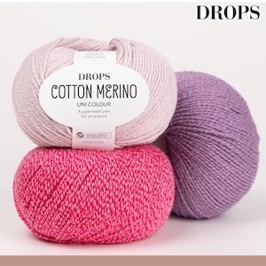 May include: Three balls of Drops Cotton Merino yarn in shades of pink and purple. The top ball is a light pink, the middle is a vibrant fuchsia, and the third is a muted purple. The top ball has a white label with the text "DROPS COTTON MERINO".