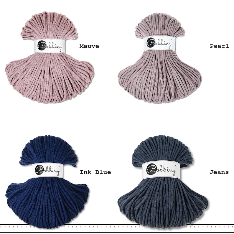 May include: Four skeins of Bobbiny cord arranged in a grid. The top left is mauve, top right is pearl, bottom left is ink blue, and bottom right is jeans. Each skein features a white paper band with the brand name Bobbiny printed in black text.