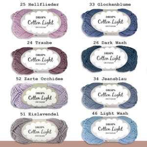 May include: Assortment of yarn skeins in various shades of purple, blue, and gray. Each skein is labeled "DROPS Cotton Light" with the brand name and color number.