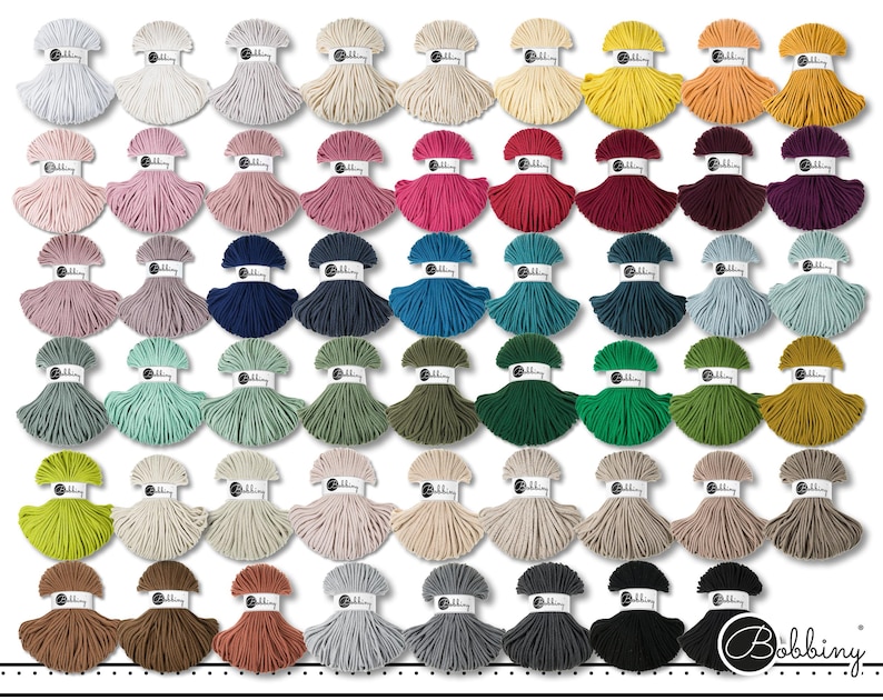 May include: A collection of fifty-four skeins of cotton cord arranged in a grid, each featuring a white paper label with the text Bobbiny. The cord is available in a wide variety of solid colors, including shades of white, pink, red, blue, green, yellow, brown, gray, and black.