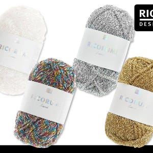 Könnte beinhalten: Vier Knäuel Rico Design Garn in Weiß, Silber, Multicolor und Gold. Jedes Knäuel hat ein weißes Etikett mit "RICORUMI" und dem Rico Design Logo. Ideal zum Stricken und Häkeln.