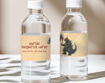 May include: Two clear water bottles with white caps. One bottle has a label with the text "CAUTION: RADIOACTIVE WATER! HANDLE WITH CARE - PARTY POWER INSIDE!" and balloons. The other bottle has a Godzilla illustration with balloons and a party hat.