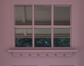 May include: A lavender-colored exterior door with a small, multi-pane window at the top. The door features a scalloped shelf below the window and a black handle and lockset. The door is framed by white trim.