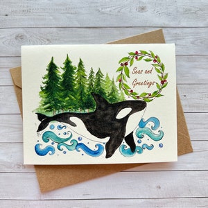 Mares y saludos. Orca navideña, tarjeta navideña, vacaciones. Tema del océano