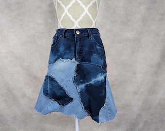 May include: A denim skirt made from patchwork pieces of blue denim. The skirt has a flared silhouette and a raw hem.
