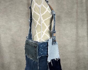 May include: A patchwork denim crossbody bag in various shades of blue. The bag has a front pocket, adjustable straps, and a raw edge design. The bag is displayed on a mannequin.