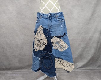 May include: A denim skirt with a patchwork design featuring lace and denim. The skirt is a midi length and has a frayed hem.
