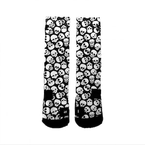 May include: A pair of black socks with a white skull pattern.