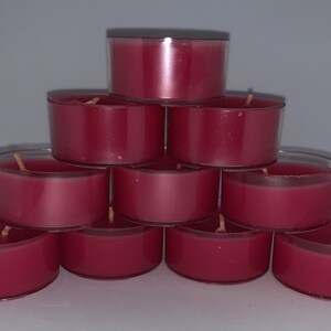 May include: A stack of ten red tea light candles in clear plastic containers.