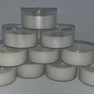 May include: A stack of ten white tea light candles in clear plastic containers. The candles are arranged in a pyramid shape.