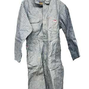 May include: A blue and white striped work jumpsuit with a red zipper and a patch on the chest that says "Big Yank".