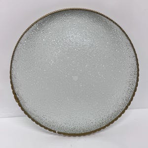 May include: A round, frosted glass ceiling light fitting with a gold metal trim.