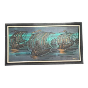 May include: An abstract painting depicting three Viking ships on teal water. The ships have brown and gold sails against a dark blue backdrop. The painting is framed in a black frame.