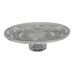 May include: A clear glass cake stand with an etched floral design. The round plate sits on a short, faceted pedestal base. The plate's edges have a scalloped design. A classic piece for displaying cakes and other desserts.