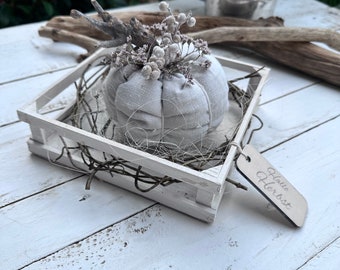 Nostalgic decorative pumpkin made of light gray linen in the country house