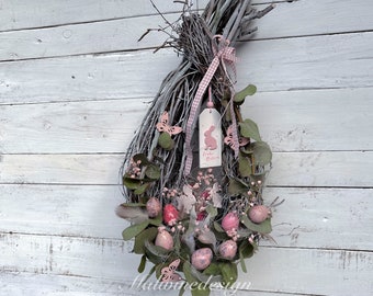 Door wreath made of birch branches Easter basket with colorful quail eggs