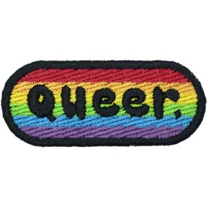 May include: Embroidered patch with the word "queer" in black, stitched onto a rainbow-colored background. The patch has a black border and a rectangular shape with rounded corners. The colors include red, orange, yellow, green, blue, and purple.