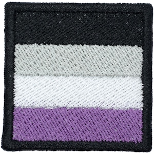 May include: A square embroidered patch featuring four horizontal stripes in black, gray, white, and purple. The entire design is framed by a thick, black stitched border, creating a clean and defined edge for this textile accessory.
