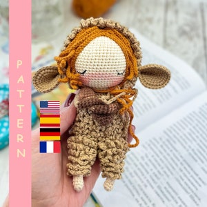 May include: A crocheted doll with brown and orange yarn, wearing a brown and orange outfit. The doll has a white face with closed eyes and a pink nose. The doll is holding a brown and orange crocheted object in its hands.