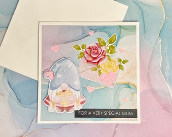 Handmade whimsical Mother's Day card with a cute gnome, flowers and pink glitter hearts
