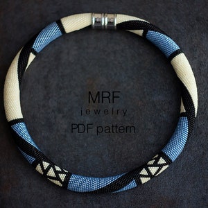 May include: A white, blue, and black beaded necklace with a geometric pattern. The necklace is made with seed beads and has a silver clasp. The necklace is on a dark gray background. MRF jewelry PDF pattern.