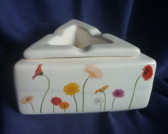 Triangular ashtray with gerberas