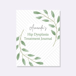 May include: A white journal cover with a green leafy design and the text "Amanda's Hip Dysplasia Treatment Journal".